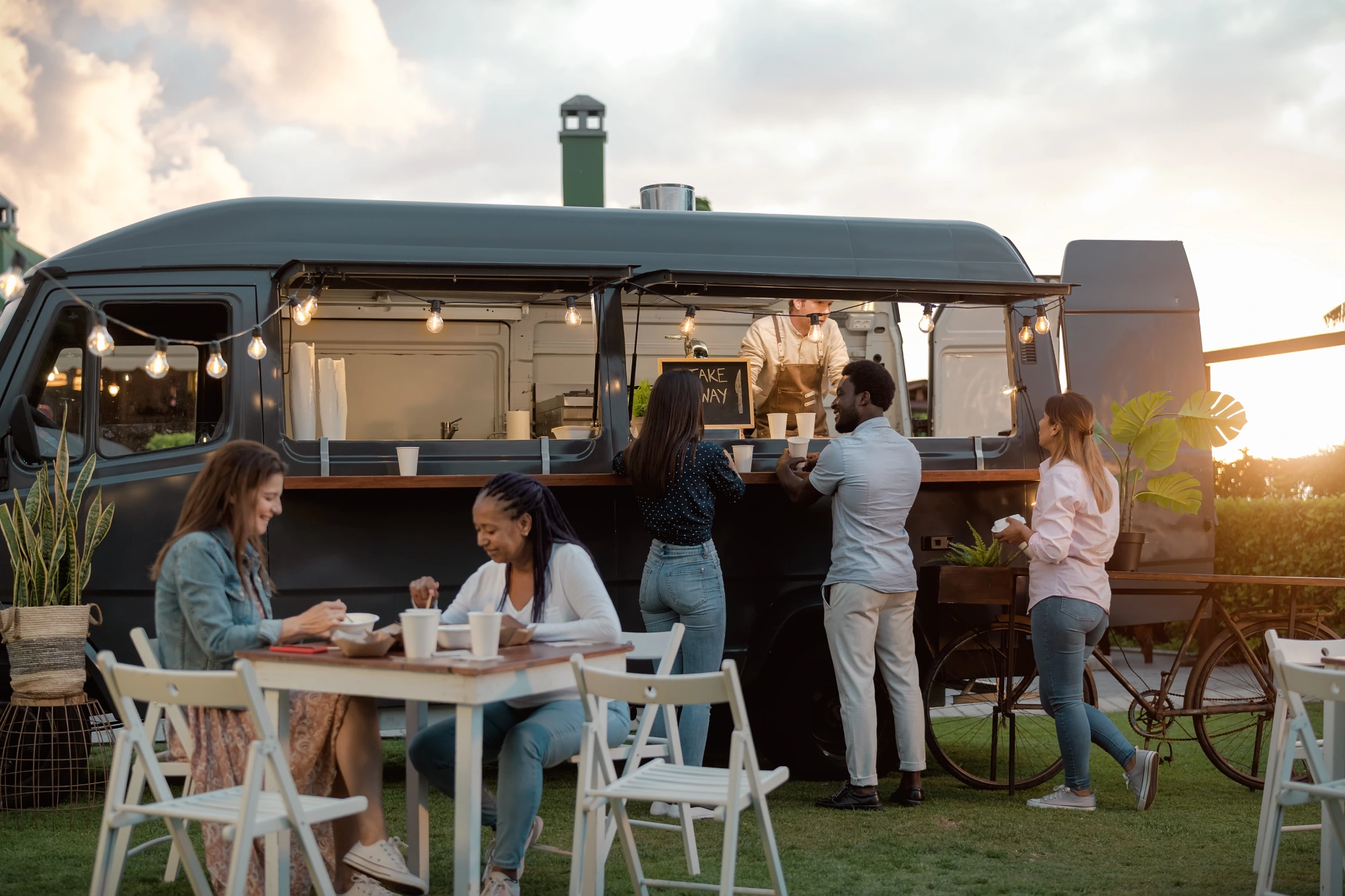 People enjoying food at a food truck.