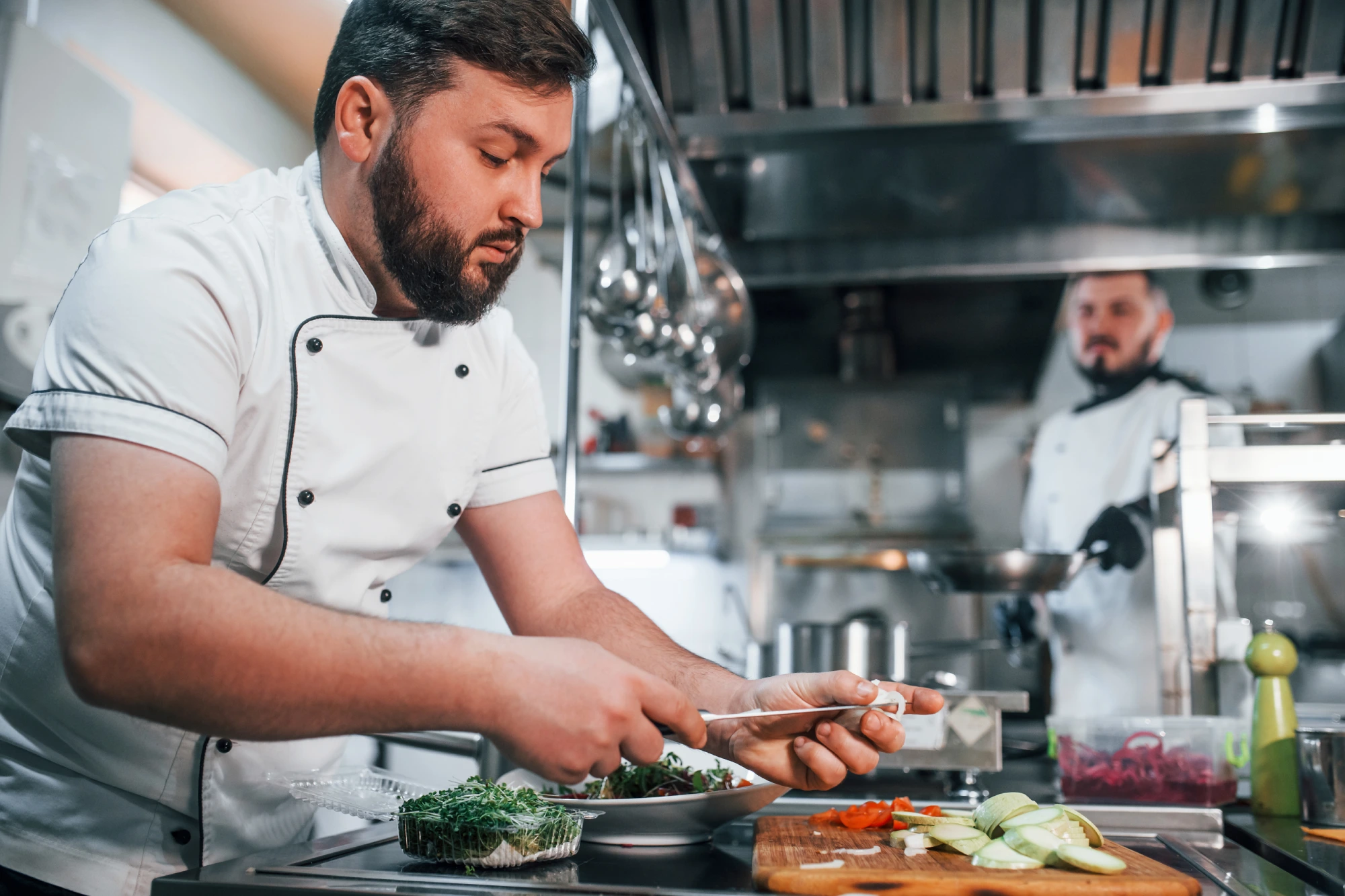 Chef preparing food in a professional kitchen.