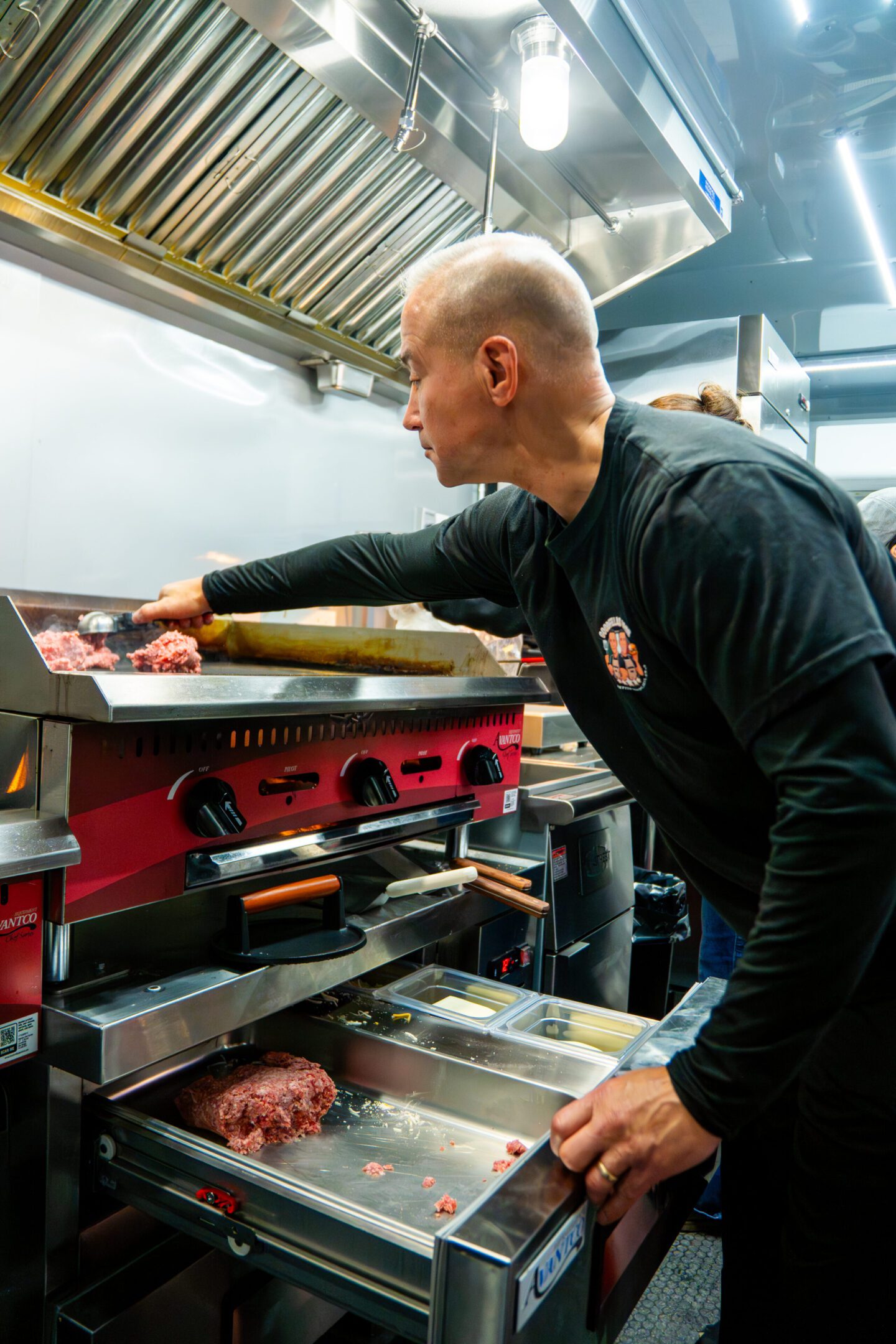 A chef preparing food in a professional kitchen.